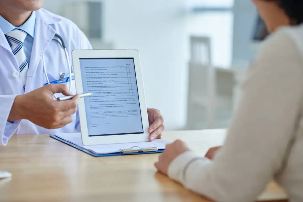 Doctor with tablet discussing Your First Pain Management Appointment Will Cover Several Important Tests